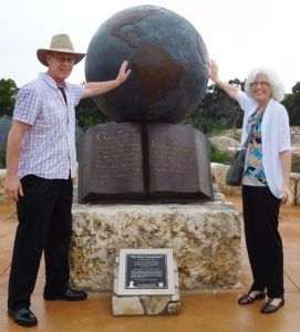 Richard and Virginia Jorgensen beside a globe sculpture